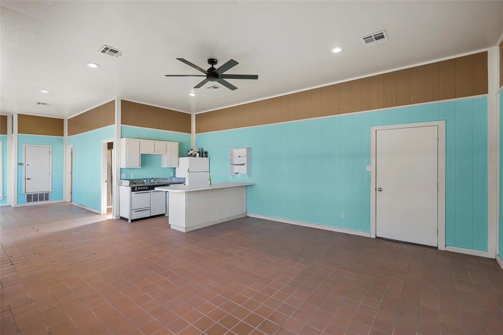 544 Lusk Creek Road Eddy, TX 76524 - Photo 31 of 39 Kitchen featuring a peninsula, light countertops, white appliances, ceiling fan, and white cabinetry