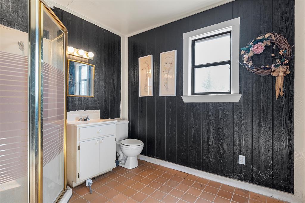 544 Lusk Creek Road Eddy, TX 76524 - Photo 33 of 39 Bathroom with vanity, a stall shower, light tile patterned floors, and wooden walls