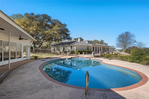 a view of a swimming pool with a patio