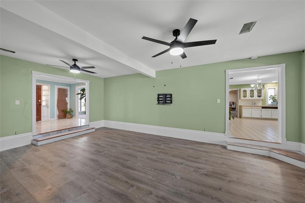 544 Lusk Creek Road Eddy, TX 76524 - Photo 6 of 39 Spare room featuring dark wood-style flooring, a ceiling fan, a chandelier, and beamed ceiling