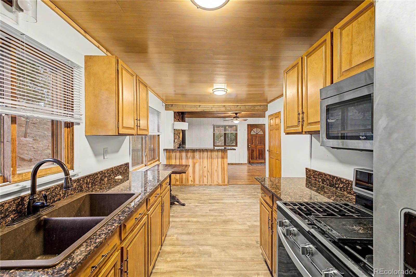 145 Bailey Drive Bailey, CO 80421 - Photo 11 of 31 a kitchen with a sink and a stove top oven