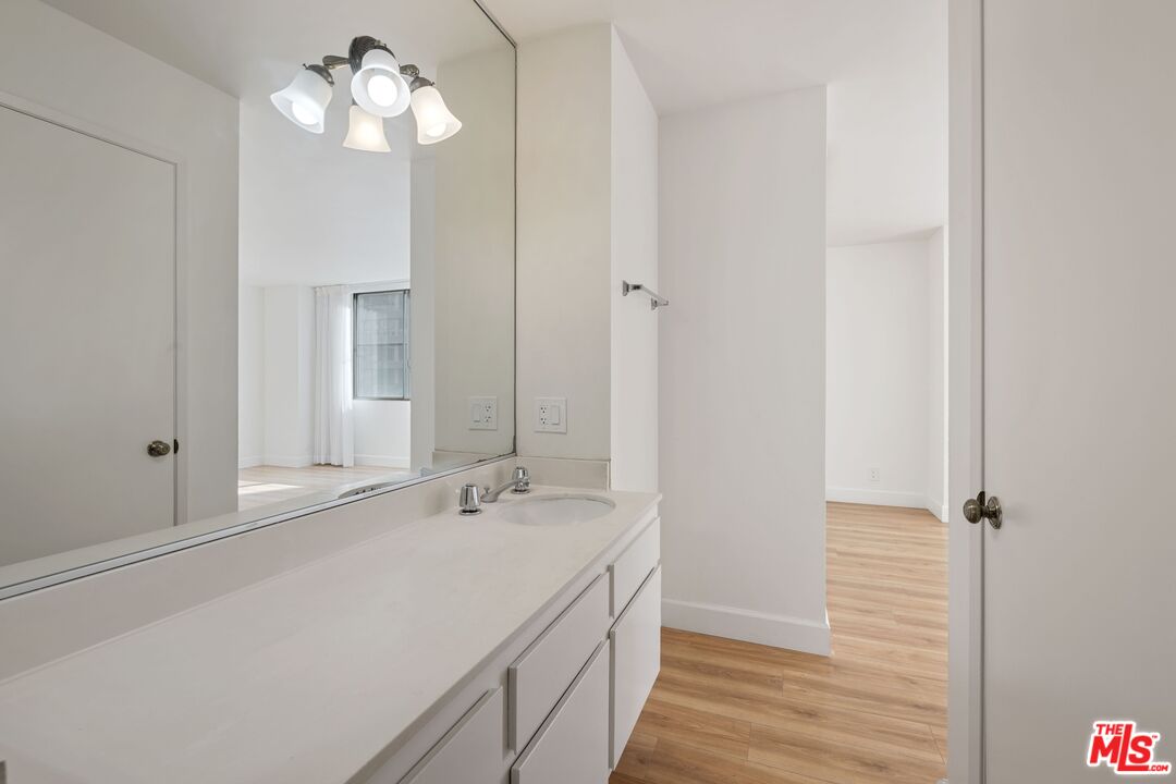 10747 Wilshire Boulevard, Unit 701 Los Angeles, CA 90024 - Photo 11 of 14 a bathroom with a double vanity sink and a mirror