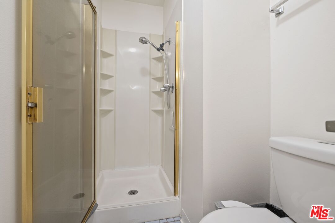 10747 Wilshire Boulevard, Unit 701 Los Angeles, CA 90024 - Photo 12 of 14 a bathroom with a shower and toilet