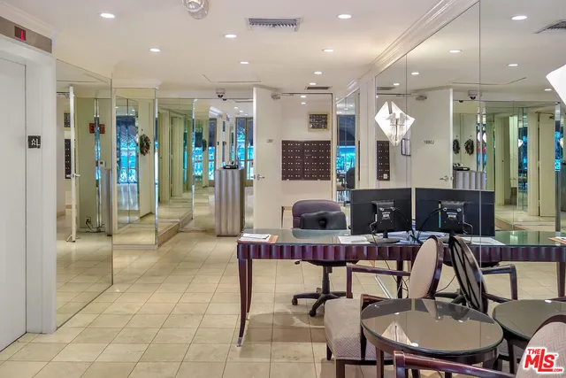 a living room with furniture a large window and stainless steel appliances