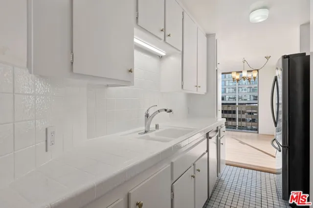 a kitchen with a sink appliances and cabinets