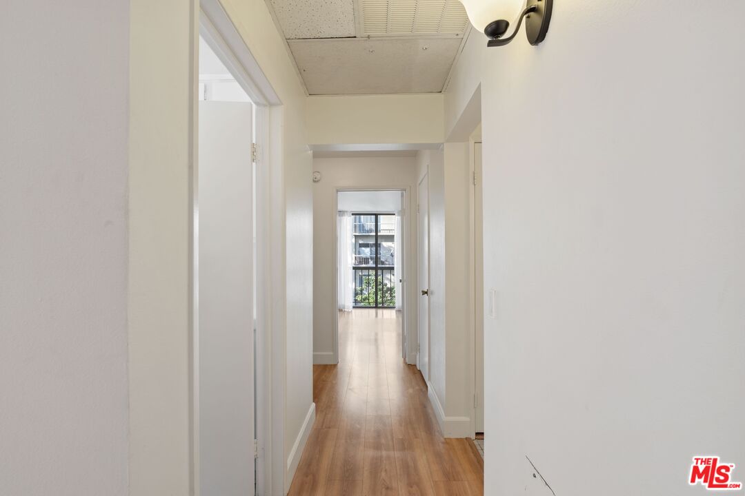 10747 Wilshire Boulevard, Unit 701 Los Angeles, CA 90024 - Photo 5 of 14 a view of a hallway with wooden floor