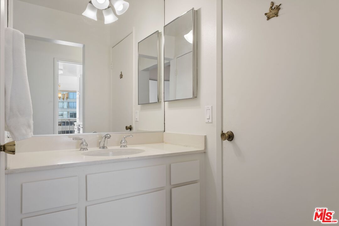 10747 Wilshire Boulevard, Unit 701 Los Angeles, CA 90024 - Photo 8 of 14 a bathroom with a sink and a mirror
