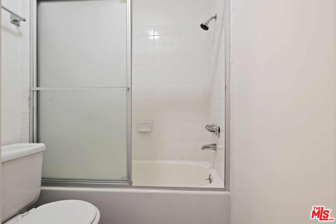 10747 Wilshire Boulevard, Unit 701 Los Angeles, CA 90024 - Photo 9 of 14 a bathroom with a toilet and a shower