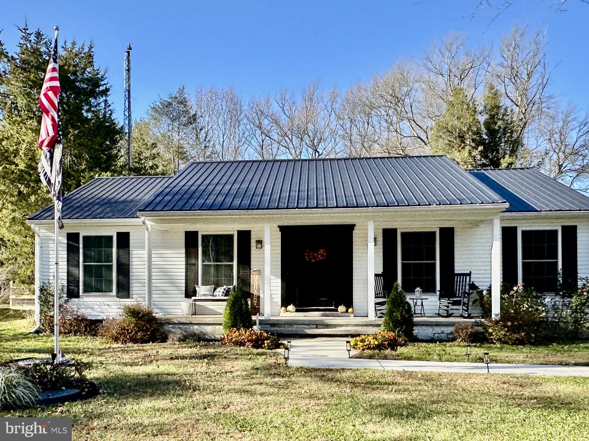 a view of a house with garden and swimming pool