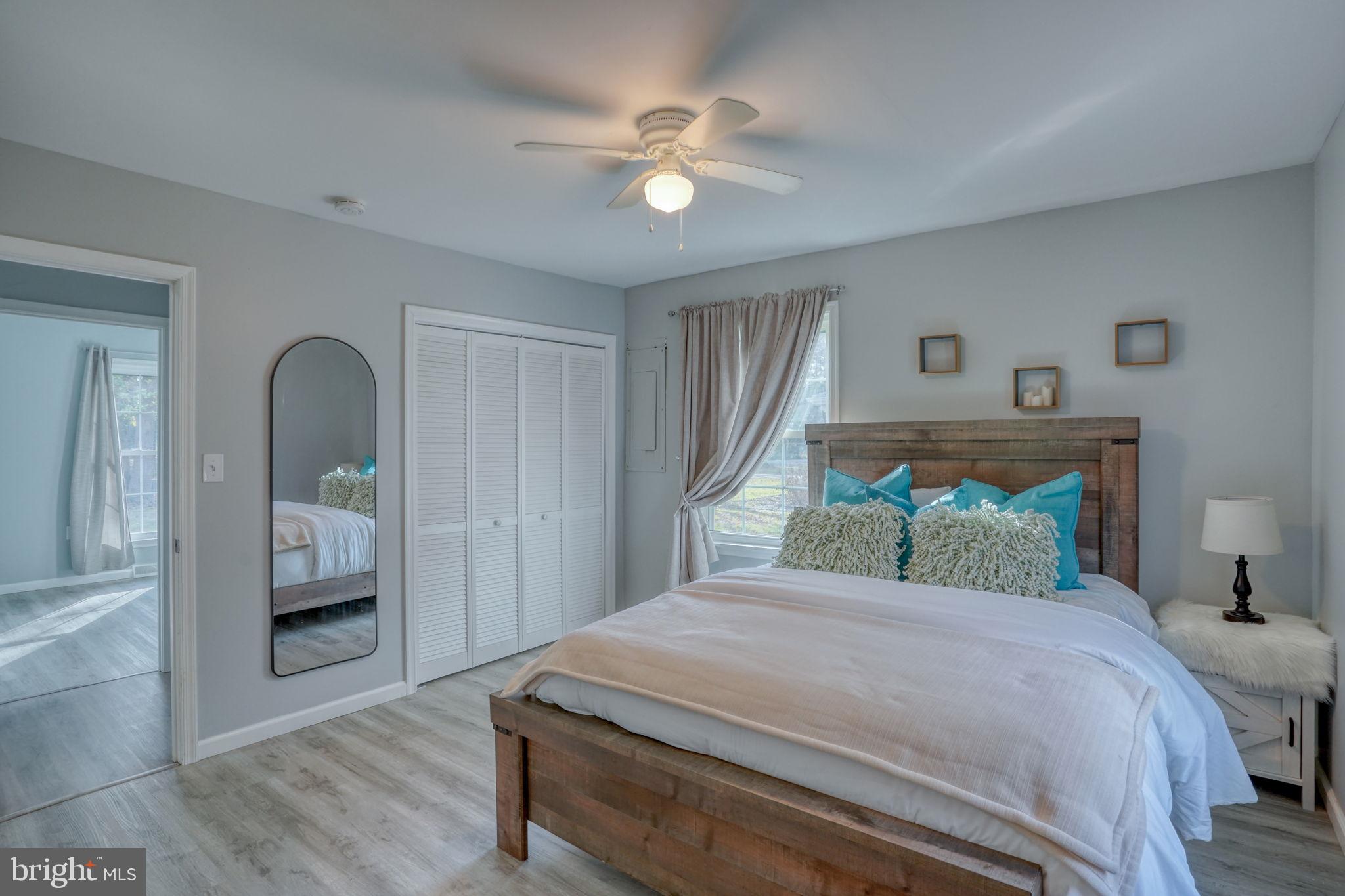 1549 Persimmon Tree Lane Dover, DE 19901 - Photo 15 of 25 a bedroom with a large bed and a window