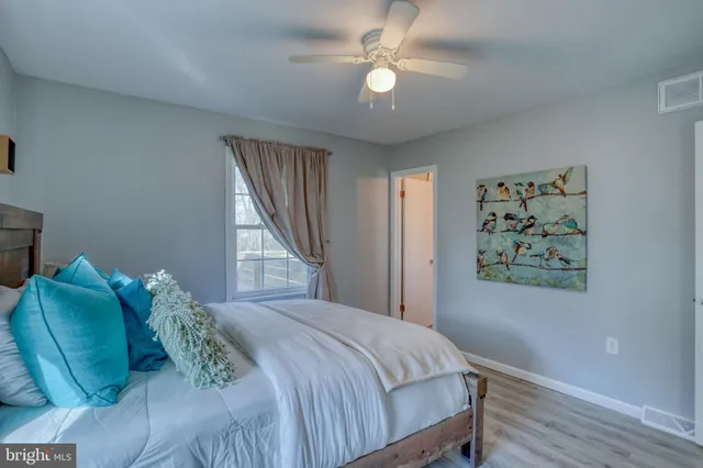 a bedroom with a large bed and a window