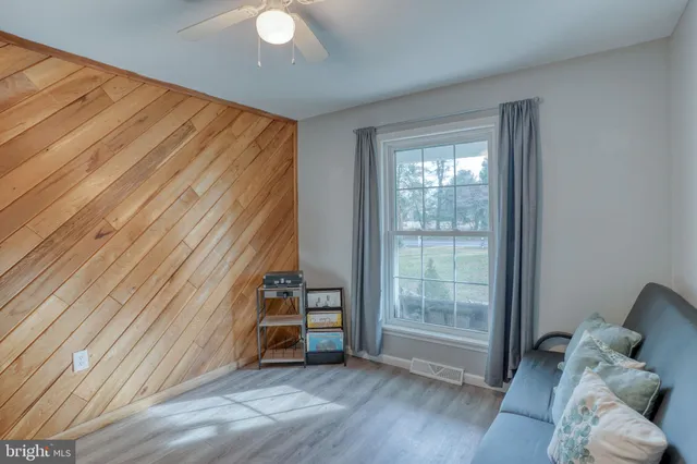 a view of room with furniture and wooden floor