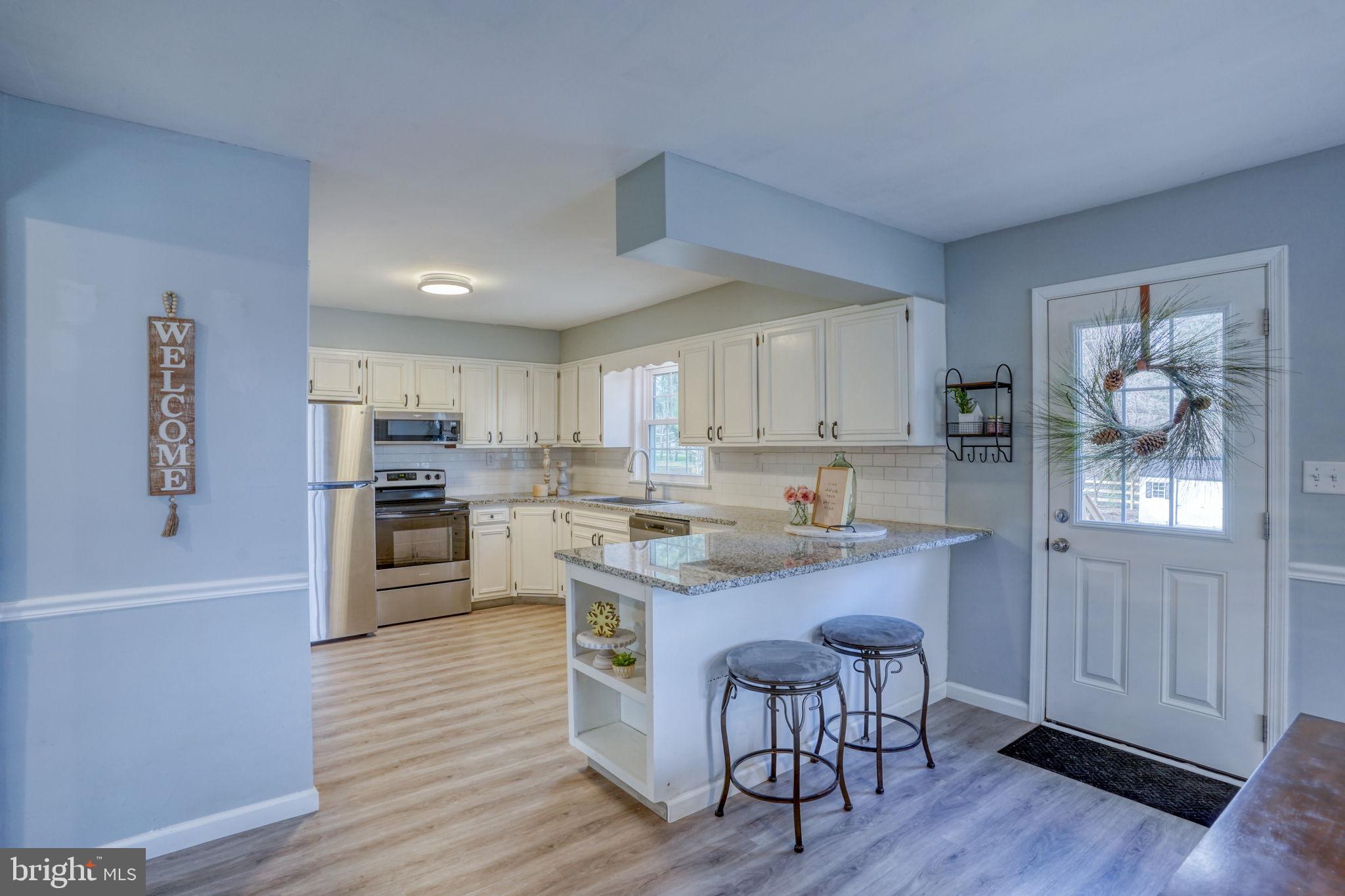 1549 Persimmon Tree Lane Dover, DE 19901 - Photo 9 of 25 a kitchen with white cabinets and appliances