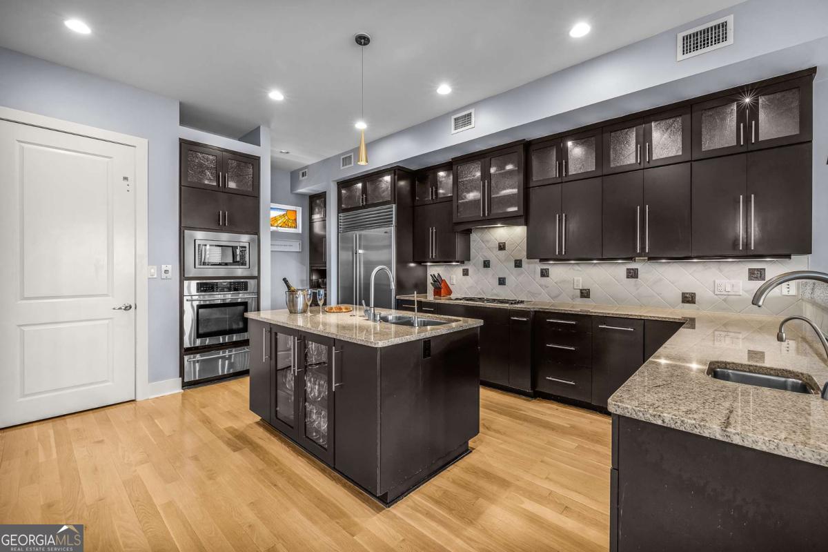8 18th Street Tybee Island, GA 31328 - Photo 19 of 50 a kitchen with stainless steel appliances granite countertop a stove and a sink