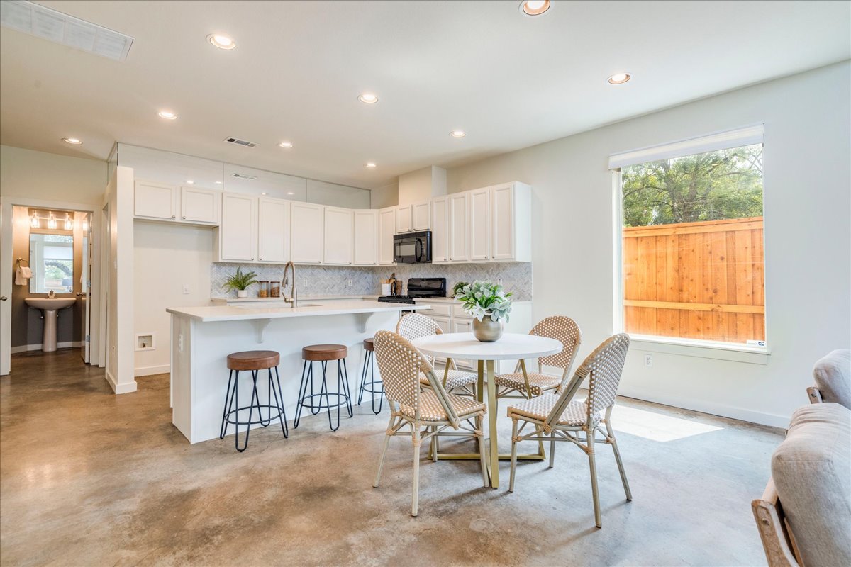 2811 Hardeman Street, Unit B Austin, TX 78704 - Photo 2 of 34 Polished concrete flooring pairs beautifully with crisp white cabinetry and recessed lighting in this kitchen.
