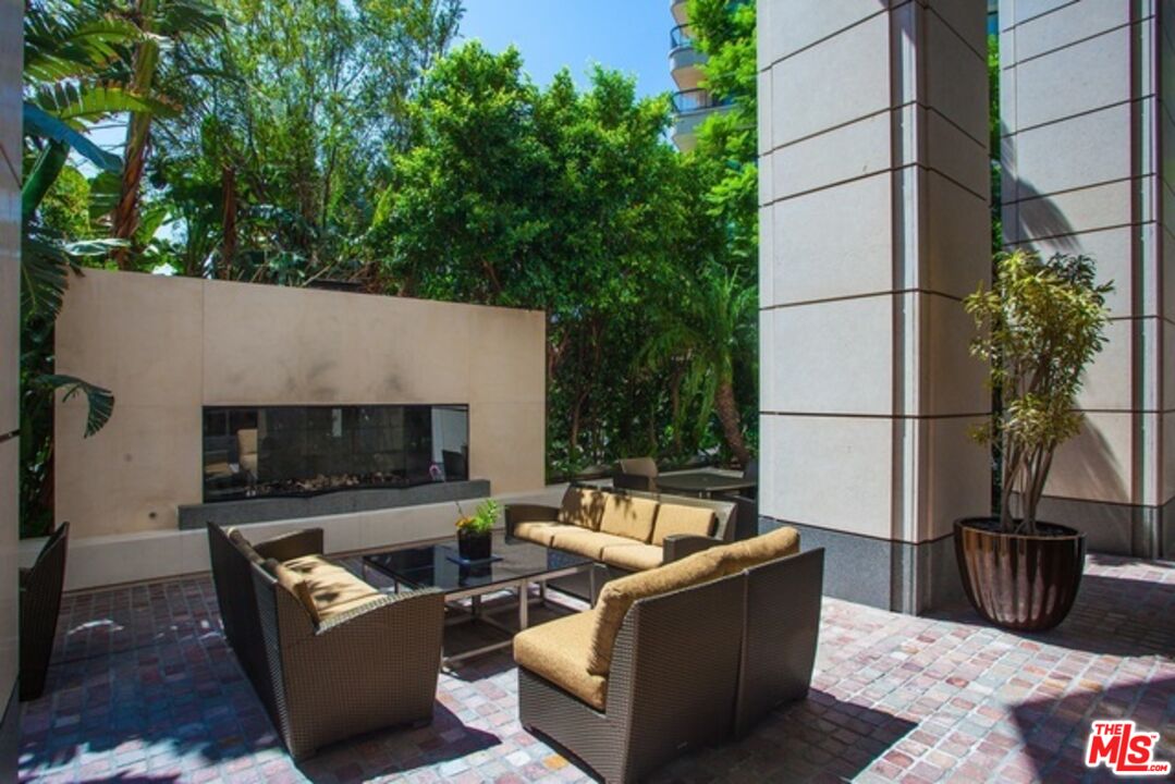10776 Wilshire Boulevard, Unit 1801 Los Angeles, CA 90024 - Photo 13 of 15 a outdoor living space with furniture potted plant and a fireplace