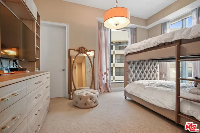 a bedroom with a bed and a chandelier