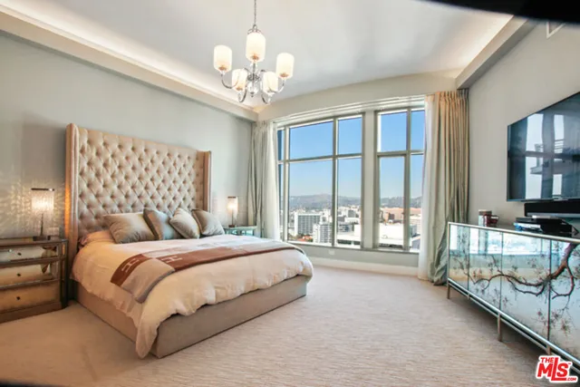 a bedroom with a large bed and a large window