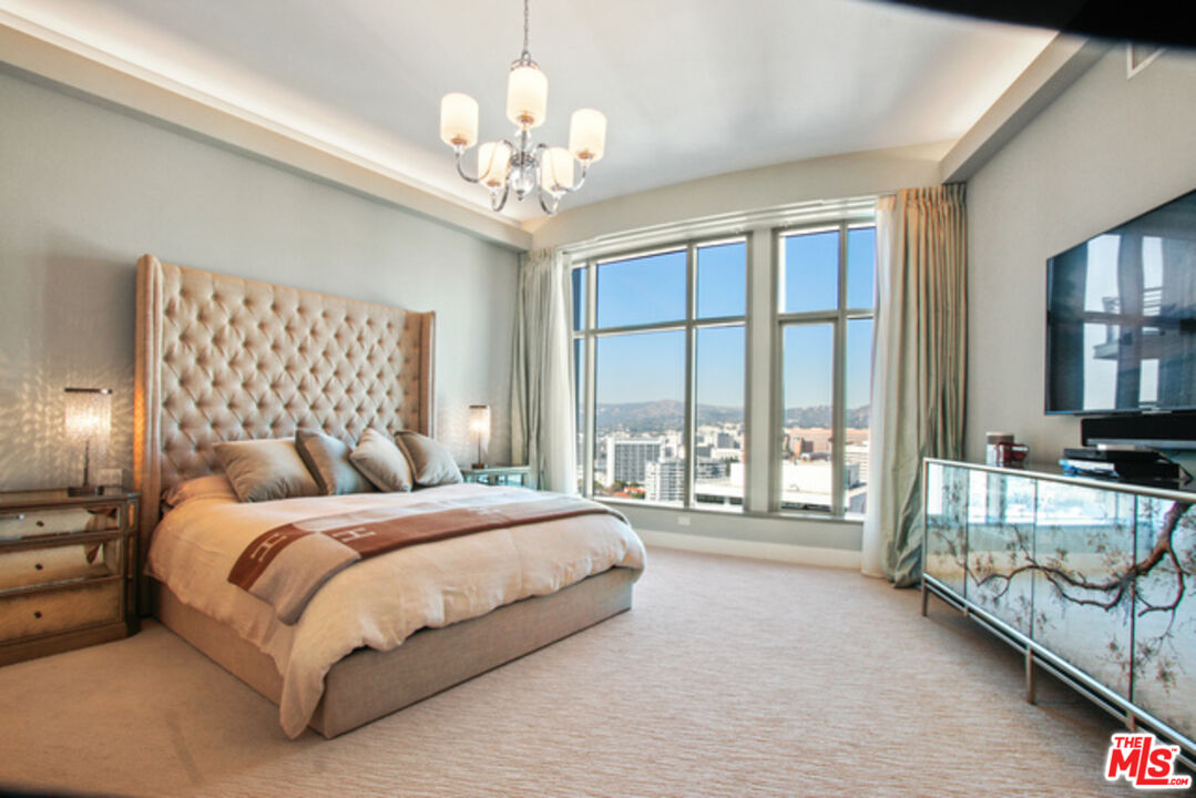 10776 Wilshire Boulevard, Unit 1801 Los Angeles, CA 90024 - Photo 9 of 15 a bedroom with a large bed and a large window