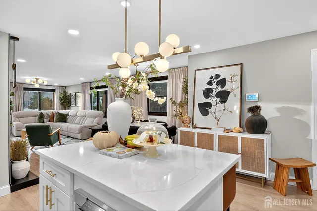 a dining room with wooden floor furniture and a chandelier