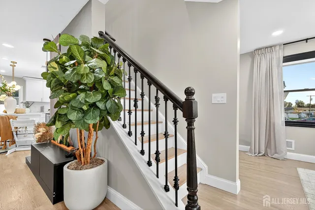a vase of flowers sitting on a table with chairs