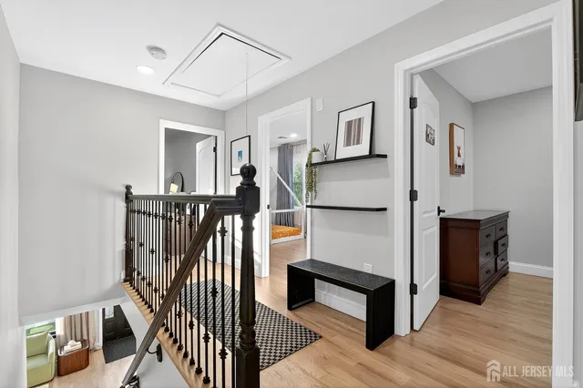 a view of entryway and hall with wooden floor