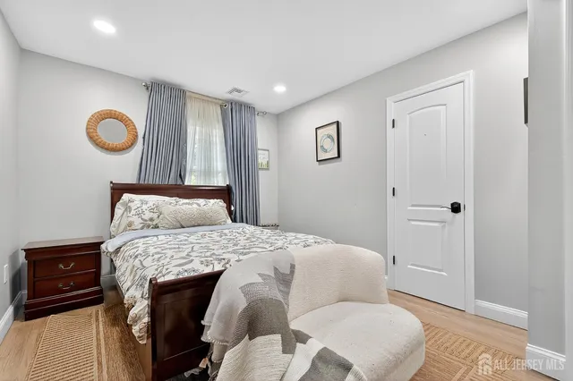 a bedroom with a bed and a lamp