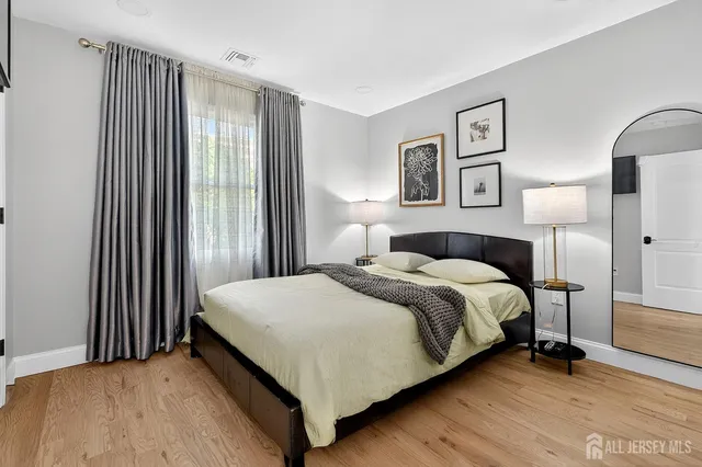 a bedroom with a bed and a night stand