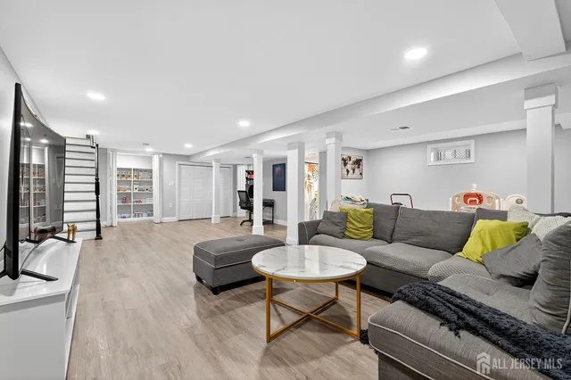 a view of a room with wooden floor closet and windows