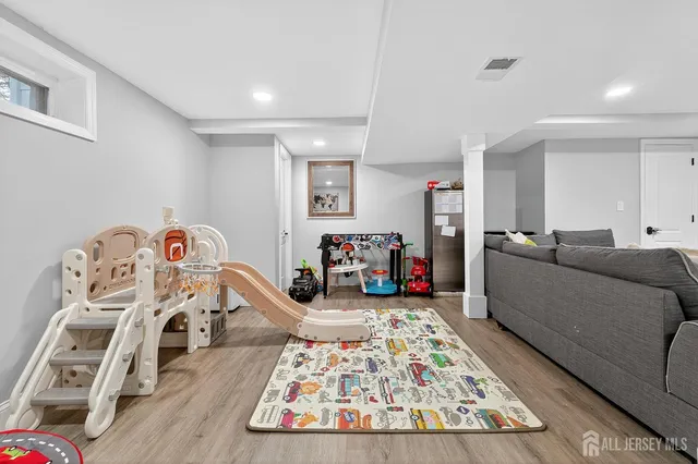 a bedroom with furniture and a wooden floor
