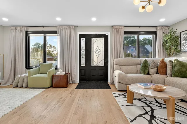 a living room with furniture and large windows