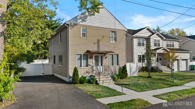 an aerial view of residential houses with outdoor space and trees