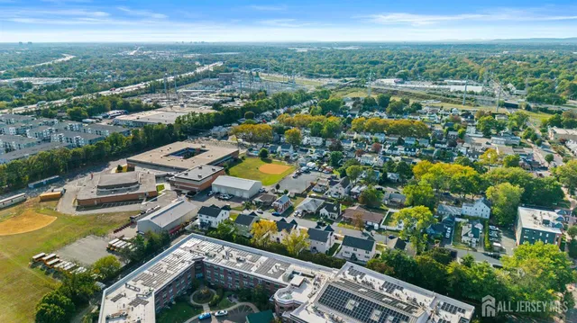 an aerial view of a house with a swimming pool and outdoor seating