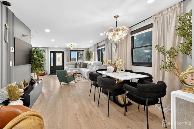 a living room with furniture potted plant and a chandelier