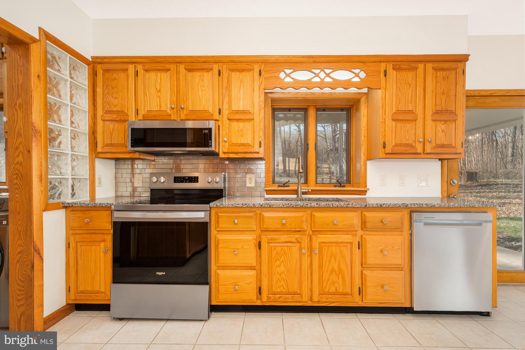 4007 White Rock Road Friendsville, MD 21531 - Photo 15 of 39 a kitchen with stainless steel appliances granite countertop a stove and a sink