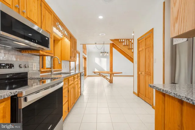 a kitchen with stainless steel appliances a sink and cabinets