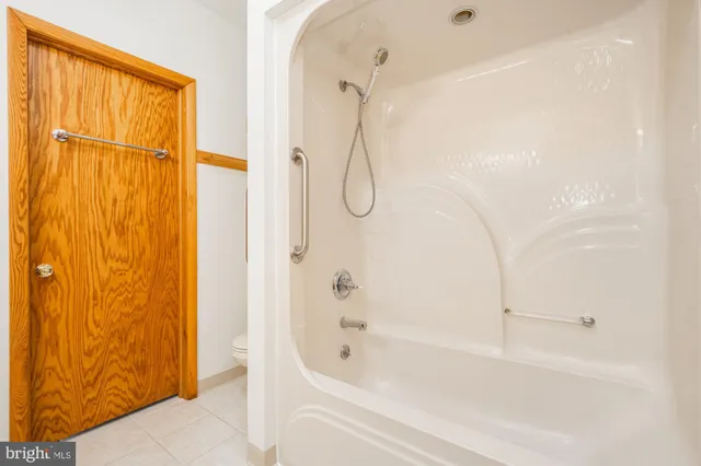 a bathroom with a bathtub and shower