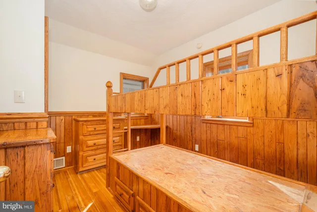 a bedroom with a bed and cabinets