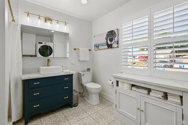 a bathroom with a toilet sink and mirror