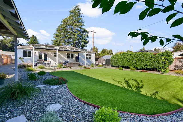 a view of a house with a backyard porch and sitting area