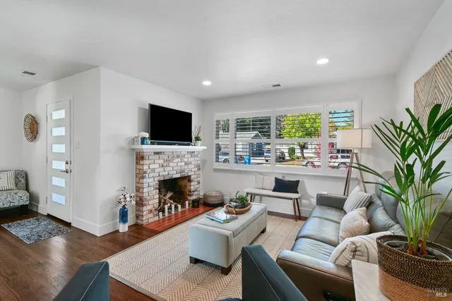 a living room with furniture a fireplace and a flat screen tv