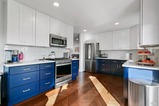 a kitchen with stainless steel appliances granite countertop a refrigerator stove and sink