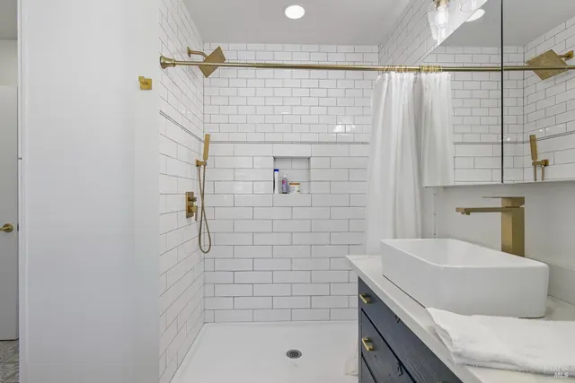 a bathroom with a bathtub and shower