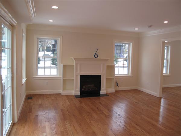 9 Larkin Road Newton, MA 02465 - Photo 2 of 4 wooden floor fireplace and windows in an empty room