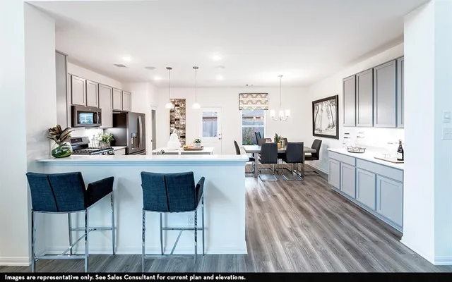 a living room with stainless steel appliances kitchen island granite countertop furniture and a kitchen view