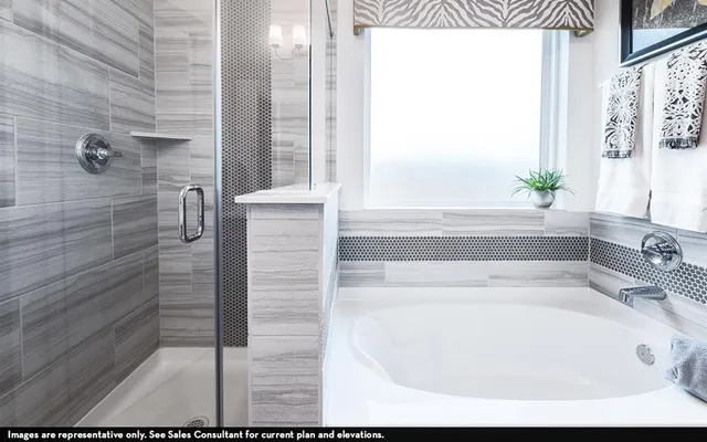 a bathroom with bathtub and window