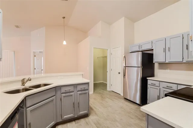 a kitchen with a sink appliances and cabinets
