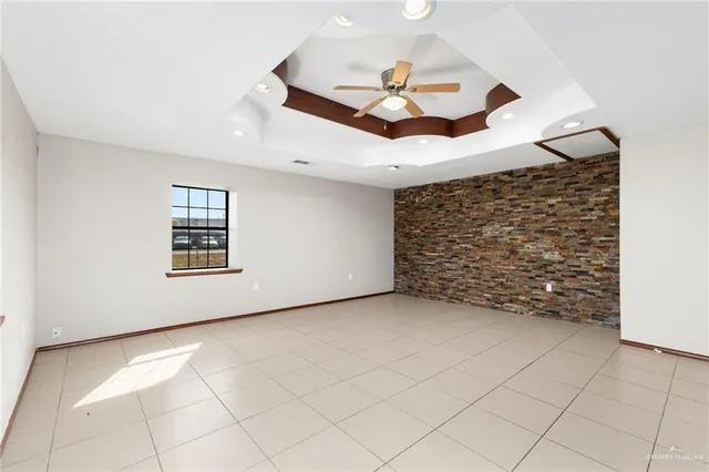 a view of a livingroom with a ceiling fan and window