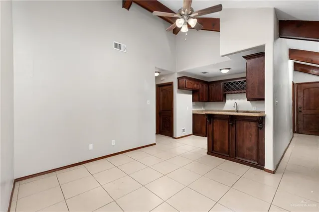 a view of kitchen with refrigerator and cabinets