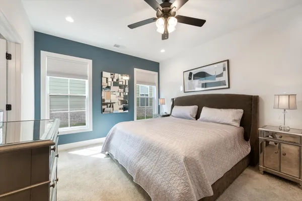 a bedroom with a large bed and a chandelier